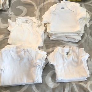 23 White assorted onesies. never worn
